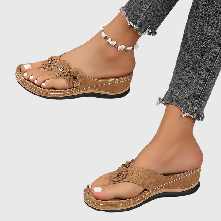 Close-up of women's orthopedic flip flops, showcasing arch support and comfortable sole.