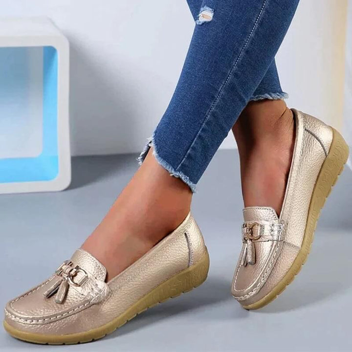 Woman wearing stylish orthopedic slip-on loafers, enjoying comfortable walking & everyday wear with foot support.