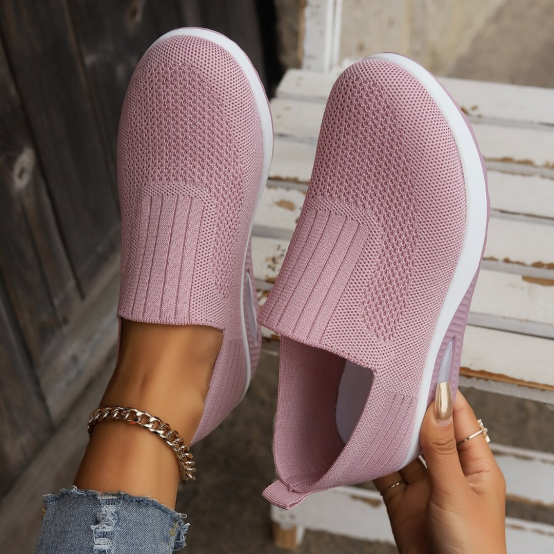 Women's orthopedic slip-on sneakers in black, offering all-day comfort, arch support, and lightweight design for walking.