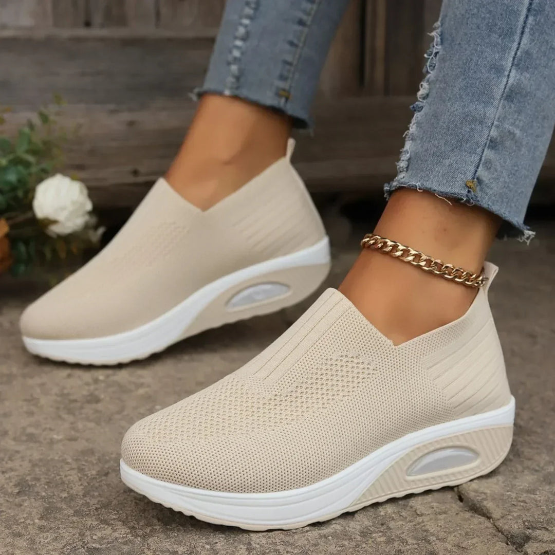Black slip-on women's sneakers providing excellent foot support, orthopedic comfort, and easy wear for daily walks.