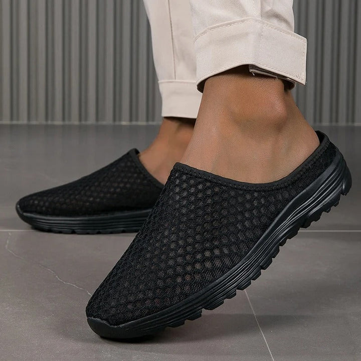 Black women's orthopedic slip-on sneakers, cushioned for comfortable everyday walking and arch support.