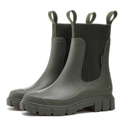 Close-up of a women's waterproof ankle boot, highlighting textured material & non-slip sole.