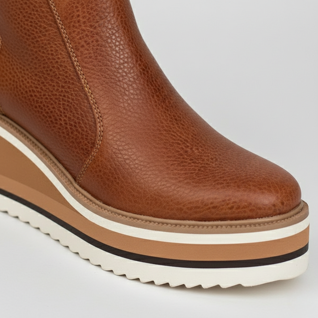 Stylish women's wedge heel ankle boots with a convenient side zipper and classic round toe. Great for winter outfits.