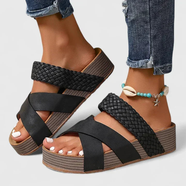 Open-toe women's wedge sandals with a unique woven crossover strap, offering orthopedic comfort & style.