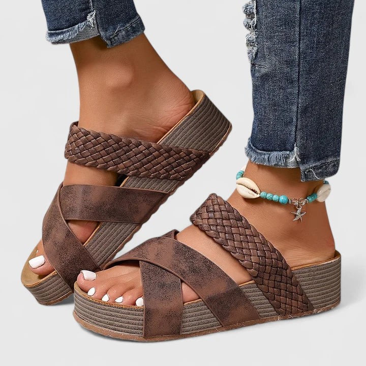Women's summer wedge sandals with a chic woven crossover strap, providing orthopedic comfort. Slip-on design.