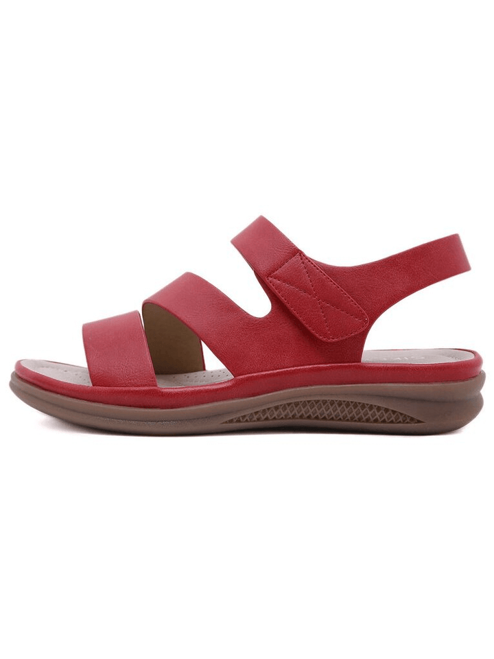 Woman wearing comfortable orthopedic wedge sandals, enjoying stable arch support on a walk.