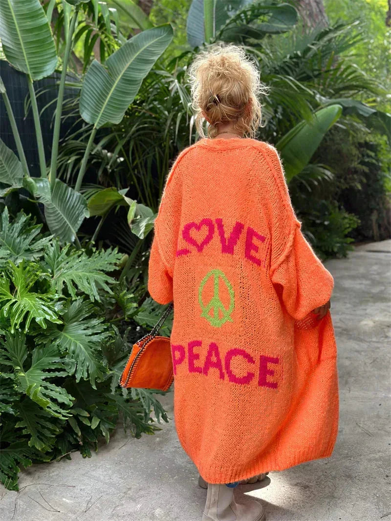 Vibrant women's oversized bohemian knit cardigan, peace love design, long and cozy.