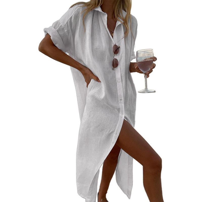 Stylish women's oversized button-down beach shirt dress, featuring roll sleeves; perfect for a chic summer look or cover-up.