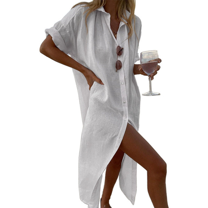 Stylish women's oversized button-down beach shirt dress, featuring roll sleeves; perfect for a chic summer look or cover-up.