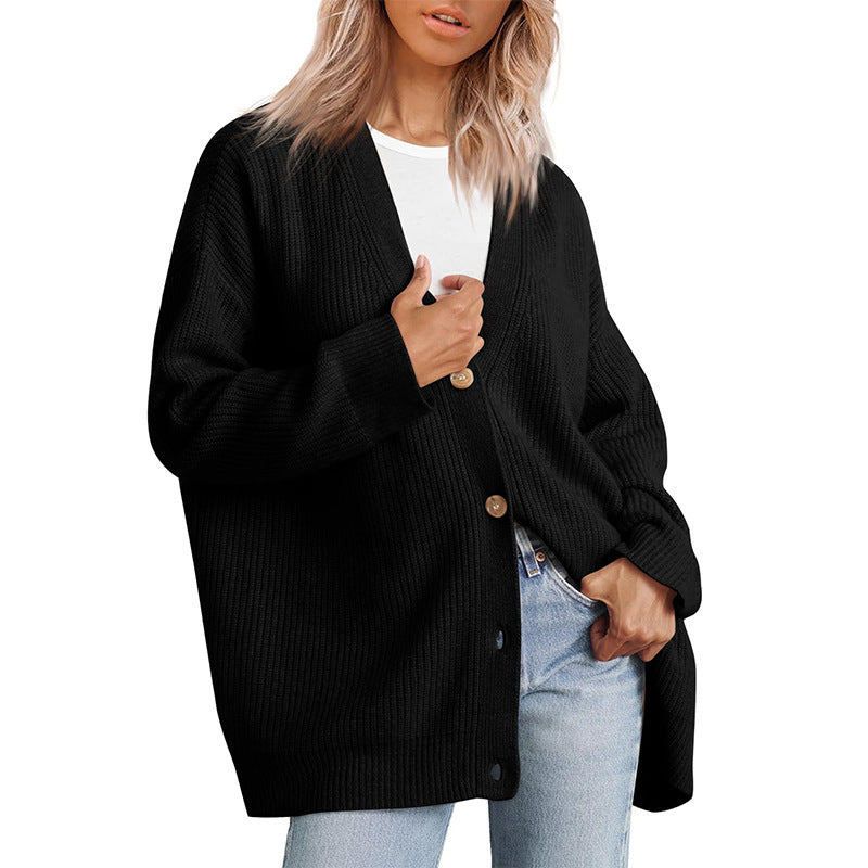 Women's oversized button-up cardigan in cozy knit, perfect for fall layering.