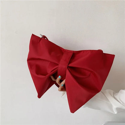 Playful women's oversized tote bag, perfect for a chic fashion statement. Features a prominent bow design.