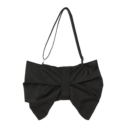 Elegant oversized bow tote bag for women. Spacious and chic, ideal for daily fashion. Canvas material.