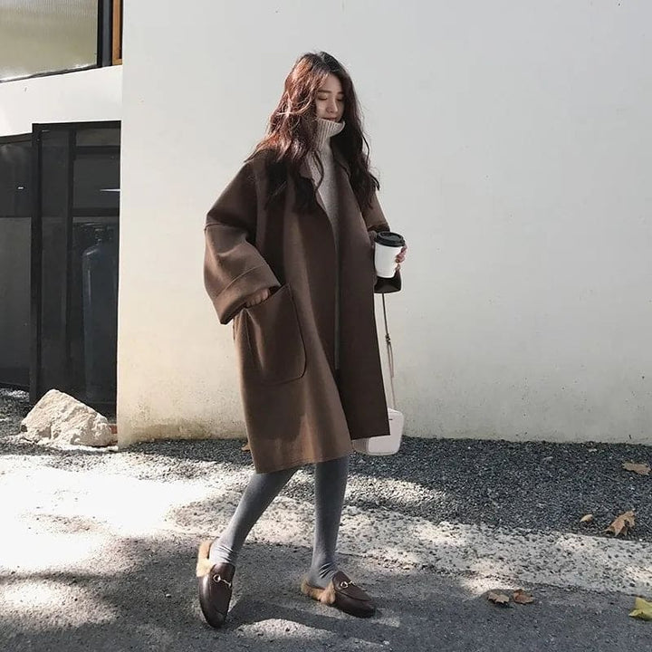 Elegant women's oversized trench coat with wide lapels. Perfect business casual outerwear for fall fashion.