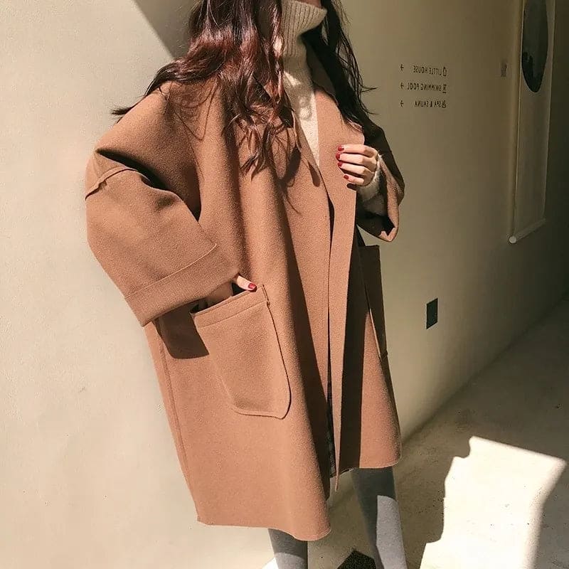 Stylish woman in an oversized elegant trench coat, ideal for business casual and classic fall fashion.