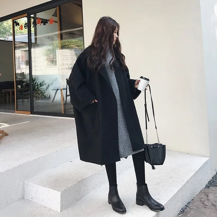 Detailed view of an elegant women's oversized trench coat with belt and button accents for stylish fall wear.