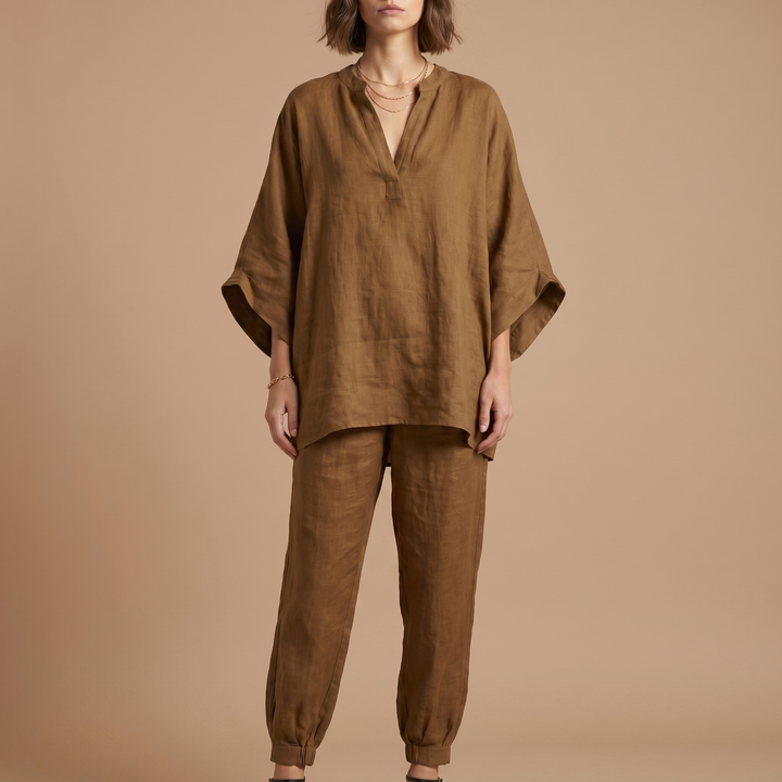 Detail shot of the soft linen blend fabric on a women's oversized tunic with batwing sleeves.