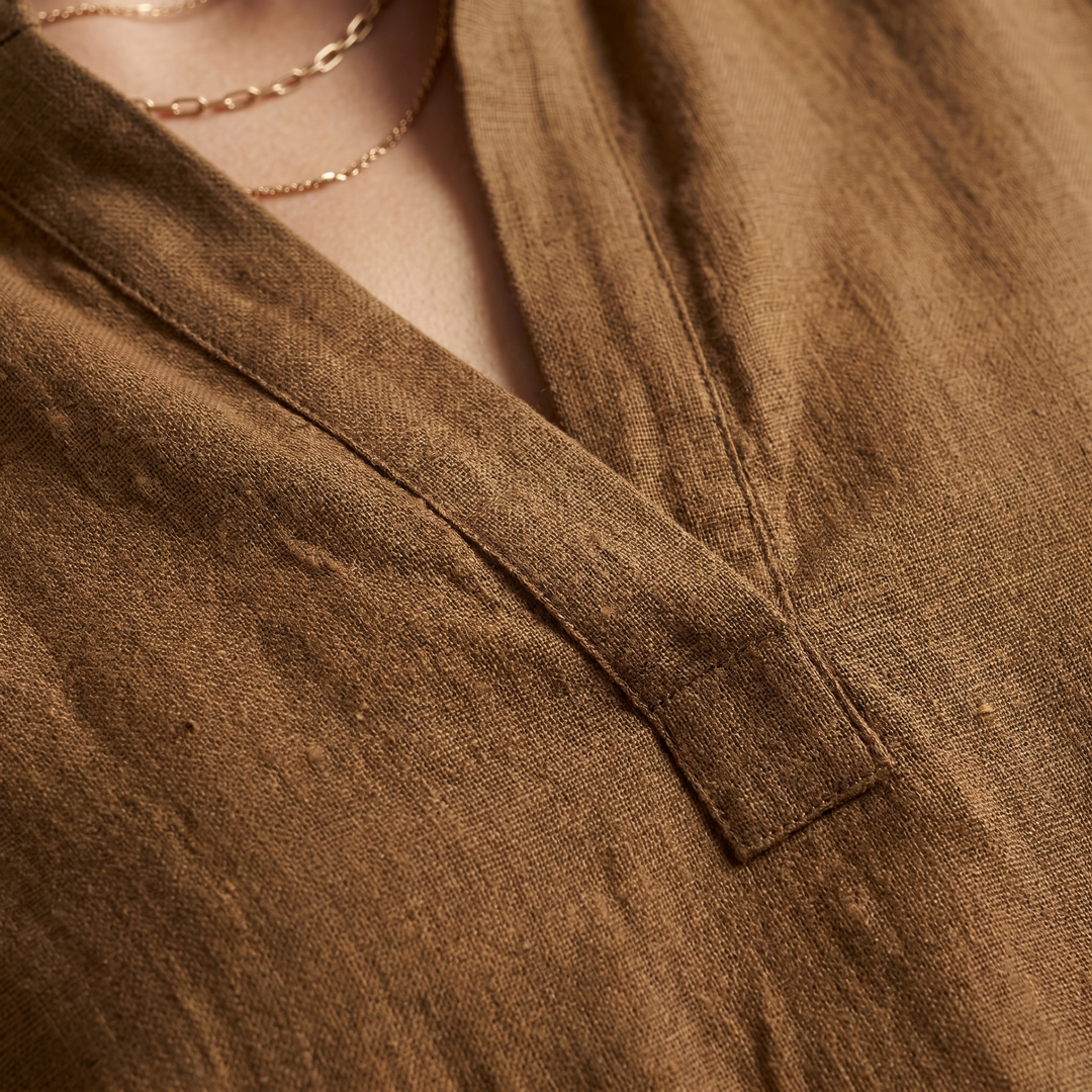 White women's oversized linen blend tunic with elegant batwing sleeves, perfect for resort or casual wear.
