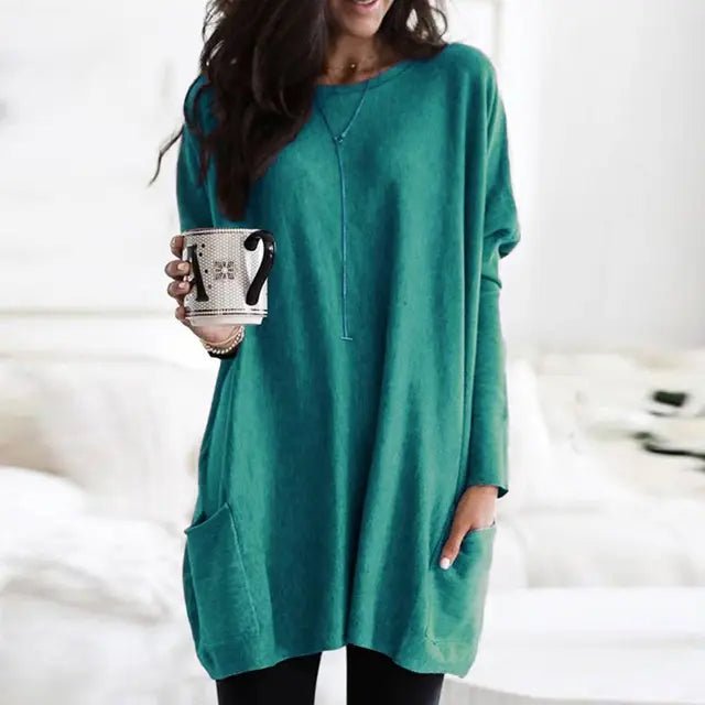 Casual crew neck women's tunic top, oversized fit, long sleeves, and handy side pockets for everyday comfort.