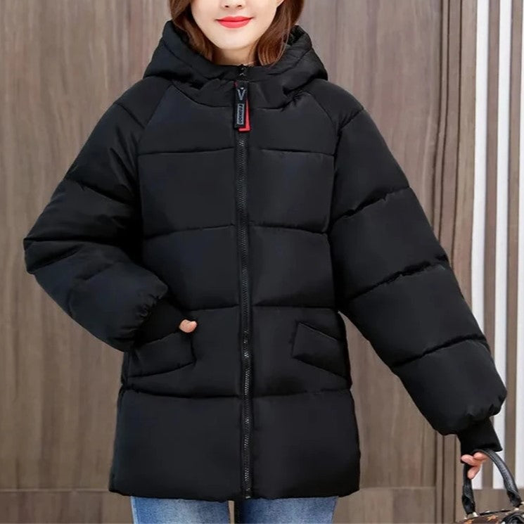 Stylish women's oversized puffer jacket, hooded, perfect for cold weather fashion 2025.