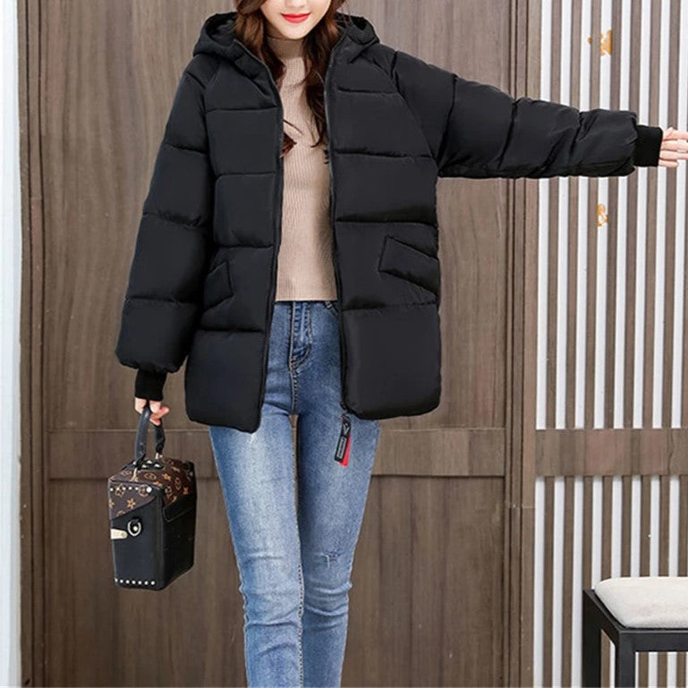 Warm women's outerwear: an oversized hooded puffer, designed for ultimate protection in winter.