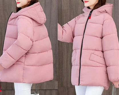 Trendy women's padded winter jacket, oversized silhouette, with a protective hood for cold.