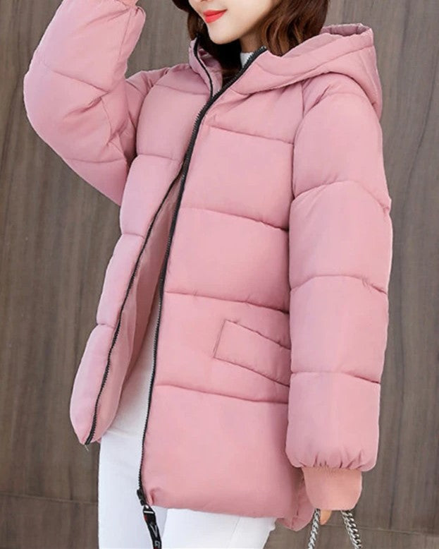 Durable women's oversized padded parka, hooded, built to withstand harsh winter conditions.