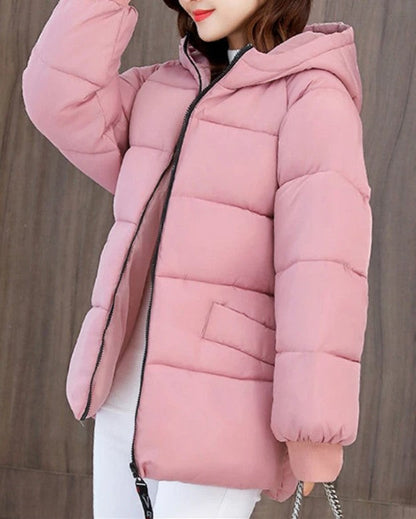 Durable women's oversized padded parka, hooded, built to withstand harsh winter conditions.