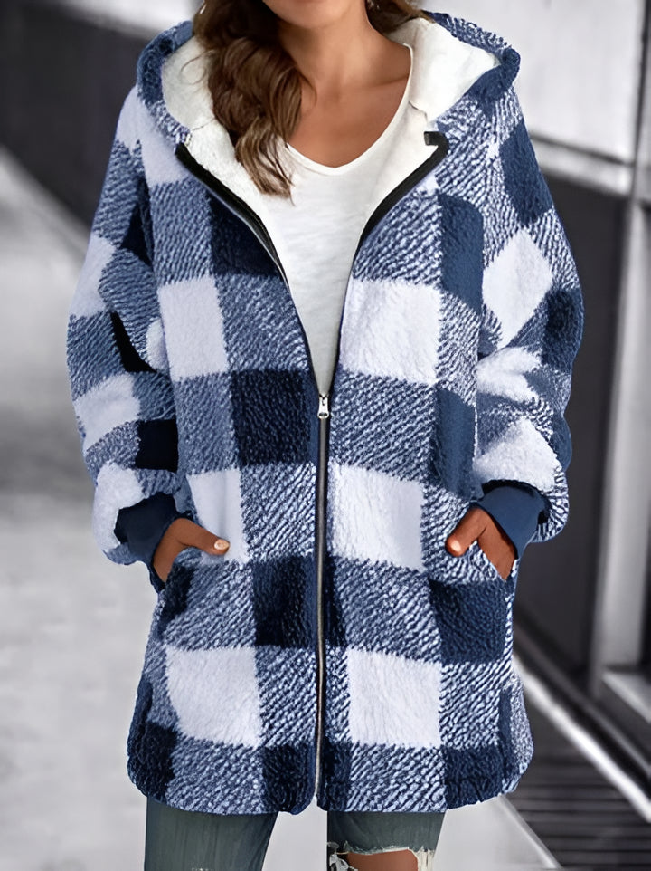 A woman wears a cozy plaid oversized hoodie, perfect for comfortable casual wear and streetwear.