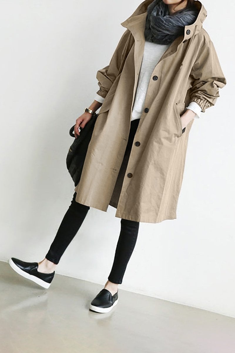 Fashionable women's rain parka. Oversized hooded trench coat for a chic, casual fall or spring look.