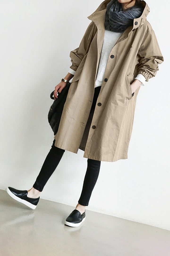 Fashionable women's rain parka. Oversized hooded trench coat for a chic, casual fall or spring look.