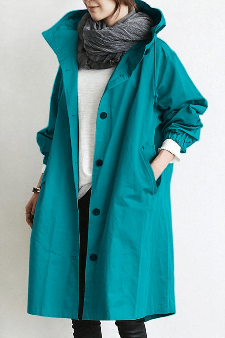 Versatile women's oversized rain parka. Stylish hooded trench coat offering weather protection & comfort.