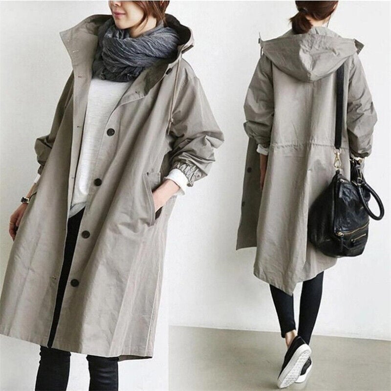 Chic women's oversized rain jacket. Modern trench coat with hood, ideal for casual and elegant styles.