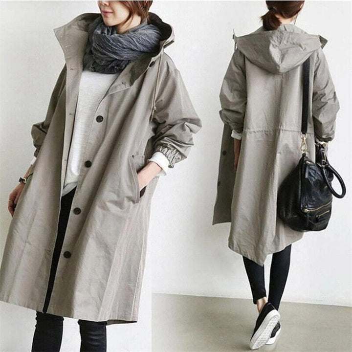 Chic women's oversized rain jacket. Modern trench coat with hood, ideal for casual and elegant styles.