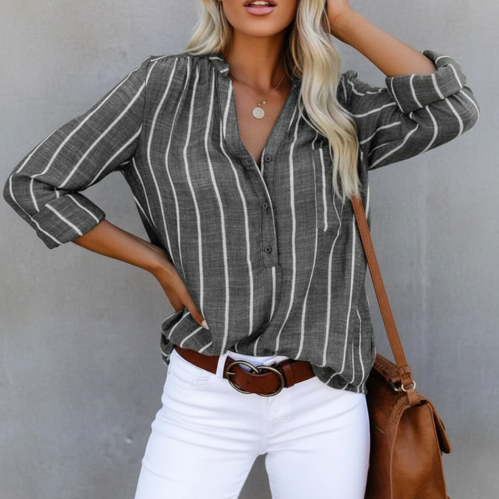 Detail shot: soft fabric of women's oversized striped shirt. Relaxed fit, long-sleeve, perfect for all-day comfort.