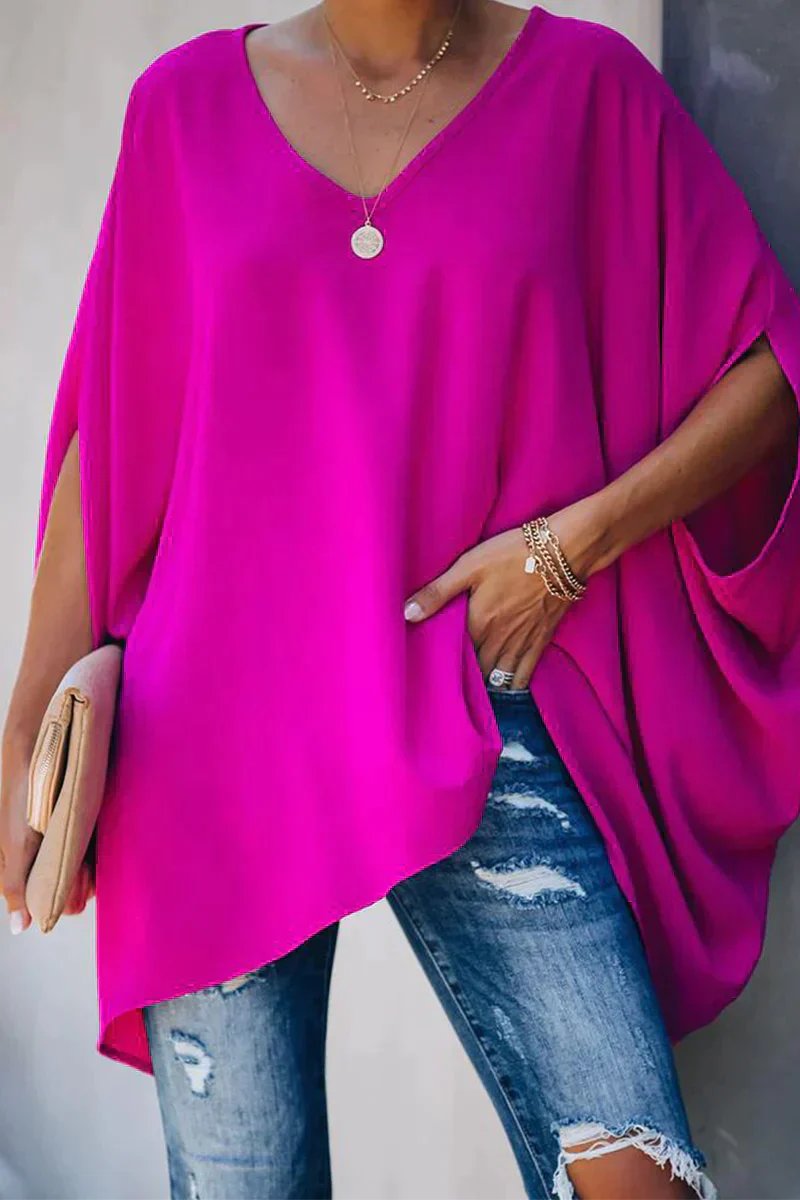 Women's oversized V-neck tunic top with stylish batwing sleeves. Relaxed fit for casual wear.