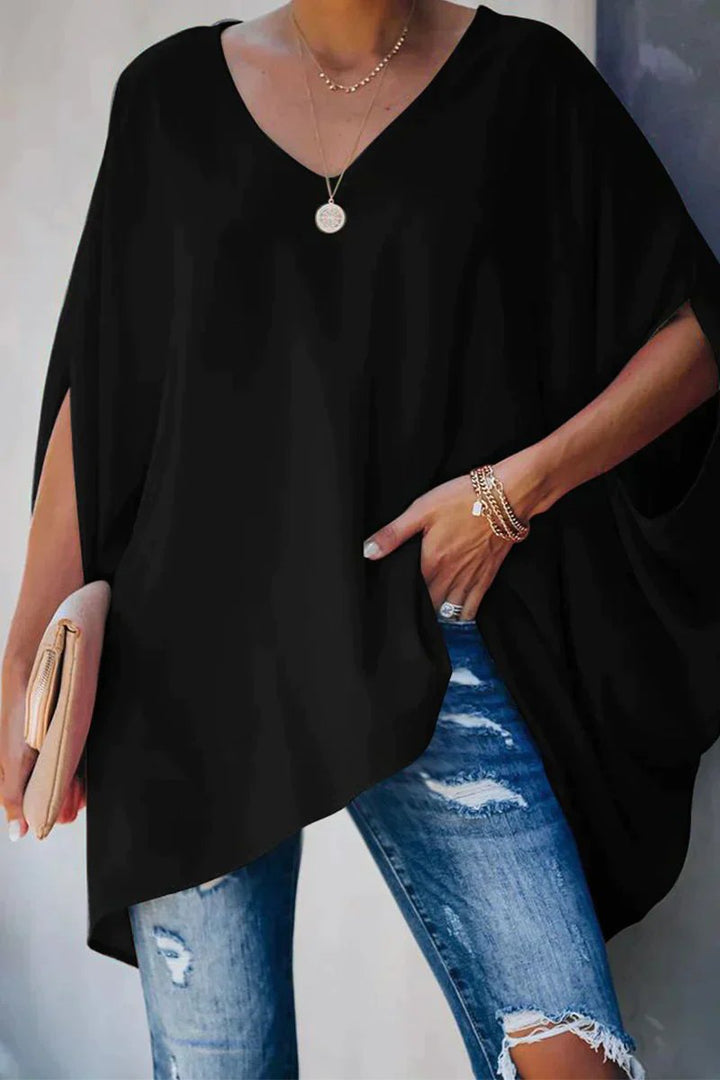 Casual women's oversized tunic top featuring a V-neck and trendy batwing sleeves.