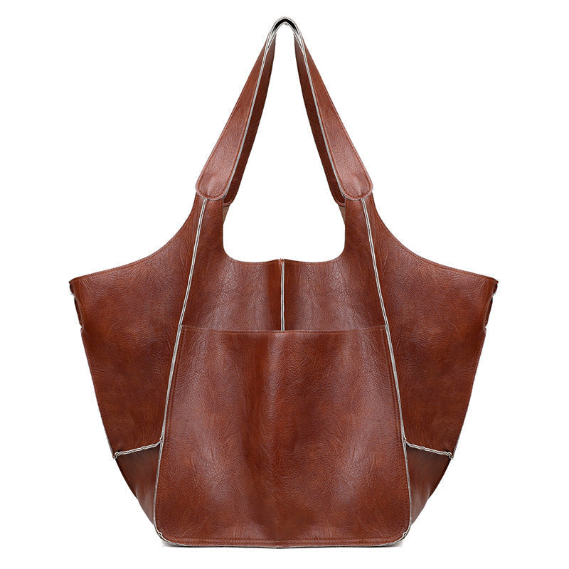 Versatile black oversized vintage leather shoulder bag for women, adaptable to any look.