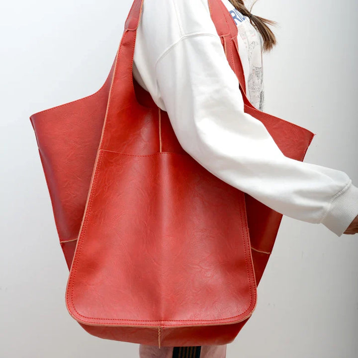 Distressed brown leather oversized shoulder bag for women, unique vintage style statement.