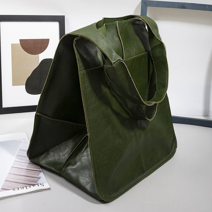 Smooth black women's oversized vintage leather shoulder bag, sophisticated daily wear.
