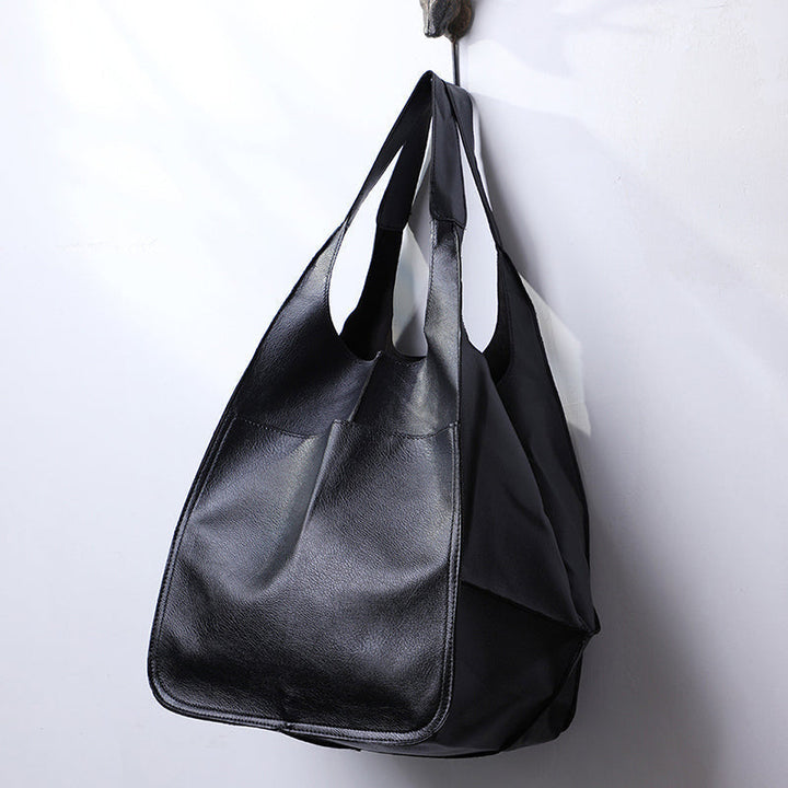 Spacious women's oversized vintage leather shoulder bag, organized storage for essentials.