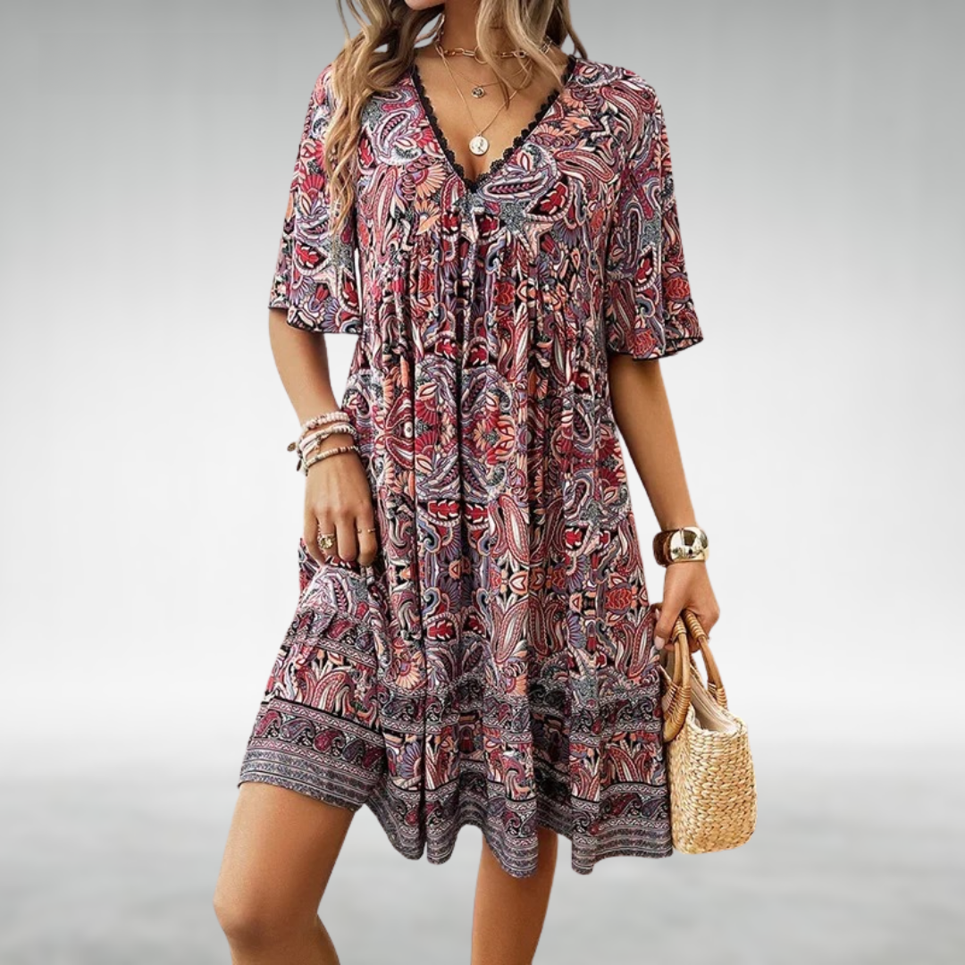 Chic paisley print babydoll mini dress for festivals, with delicate lace trim and a flowy ruffle hem.