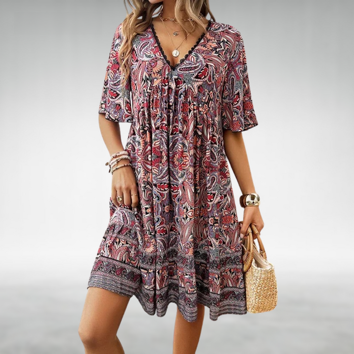 Chic paisley print babydoll mini dress for festivals, with delicate lace trim and a flowy ruffle hem.