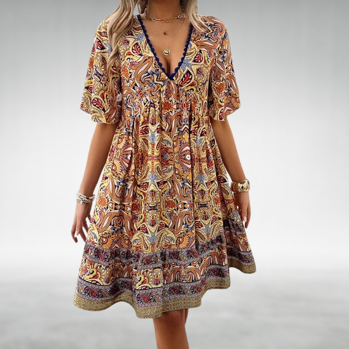 Stylish women's spring/summer boho mini dress, featuring a paisley pattern, lace, and a playful ruffle hem.