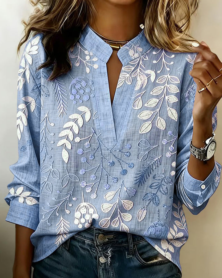 Elegant women's blouse featuring a lovely pastel floral print and a flattering V-neckline.