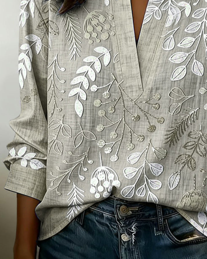 Women's pastel floral print V-neck top, perfect for a relaxed yet elegant summer outfit.