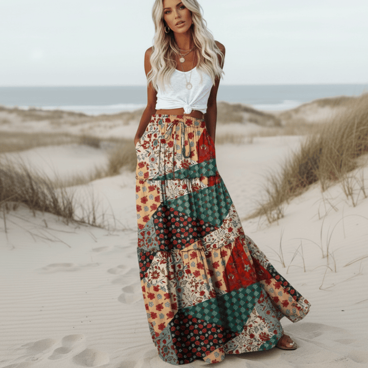Bohemian women's flowy long maxi skirt featuring patchwork floral print & comfortable elastic waist for casual wear.