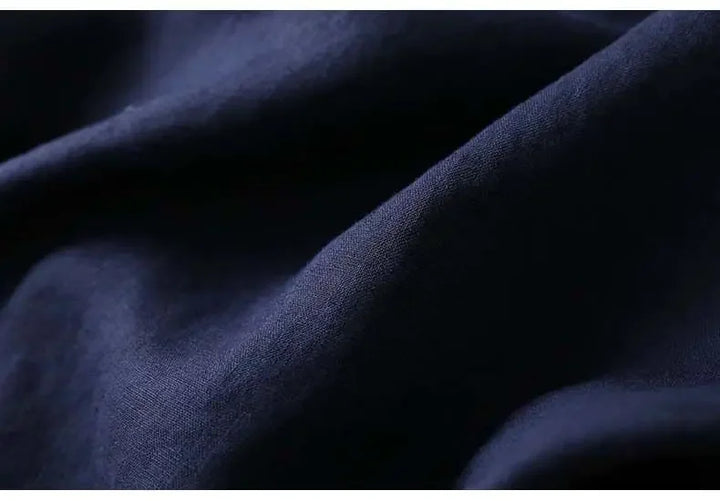 Embroidered navy blue patterned women's blouse, relaxed fit, V-neck. Stylish & comfortable.