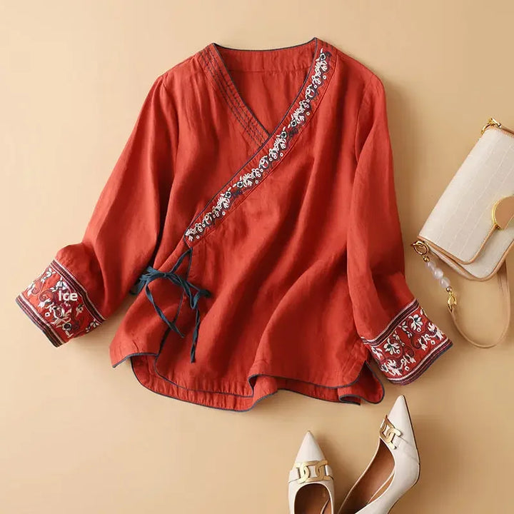 Elegant women's patterned long sleeve blouse, relaxed fit, stylish V-neck design.