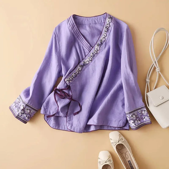 Purple patterned women's blouse, relaxed fit, elegant V-neck. Comfortable long sleeve top.