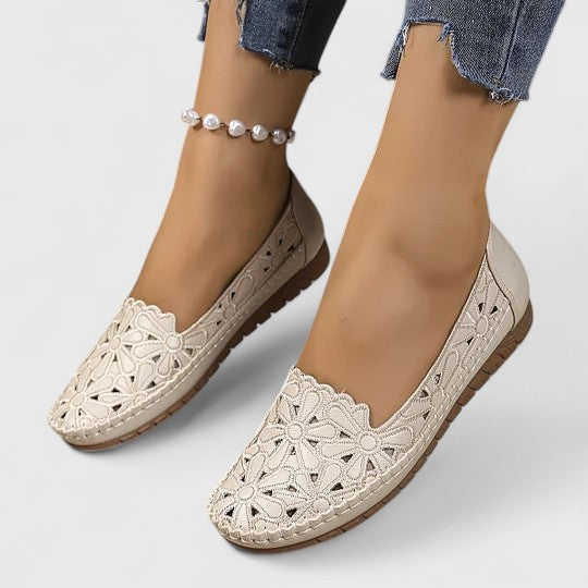 Women's comfortable slip-on ballet flats with breathable floral perforation, round toe, and elegant scalloped edge.